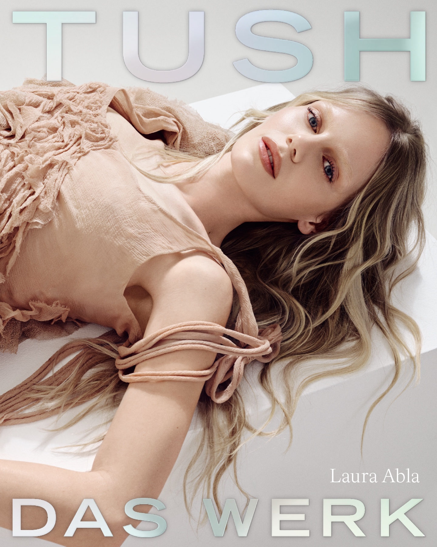 Cover of TUSH magazine featuring model Laura Abla reclining in a textured beige dress.
