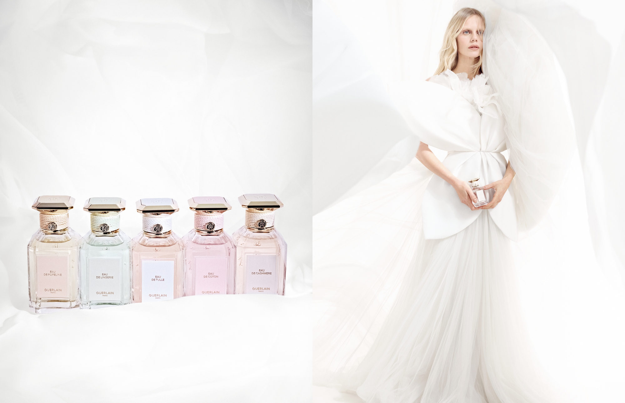 Five pastel Guerlain perfume bottles lined up beside a woman posing in a voluminous white tulle gown.