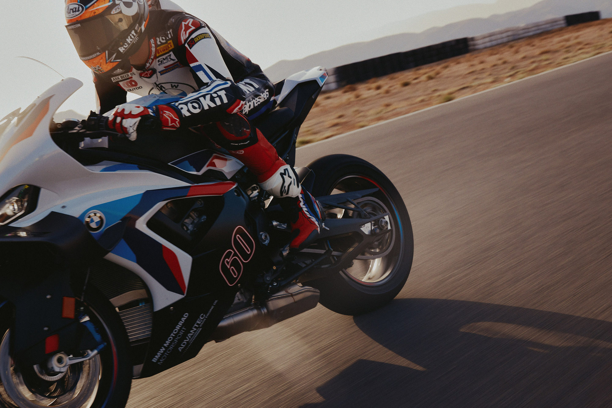 Close-up action shot of a BMW M 1000 RR motorcycle on a racetrack