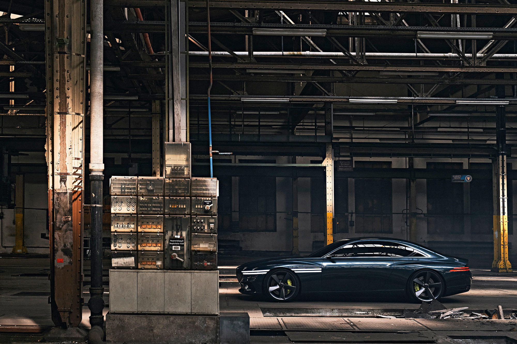 Genesis concept car parked inside a large industrial warehouse