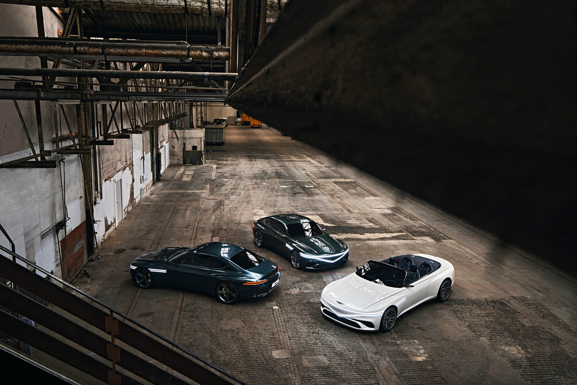 Three Genesis concept cars photographed inside an industrial warehouse