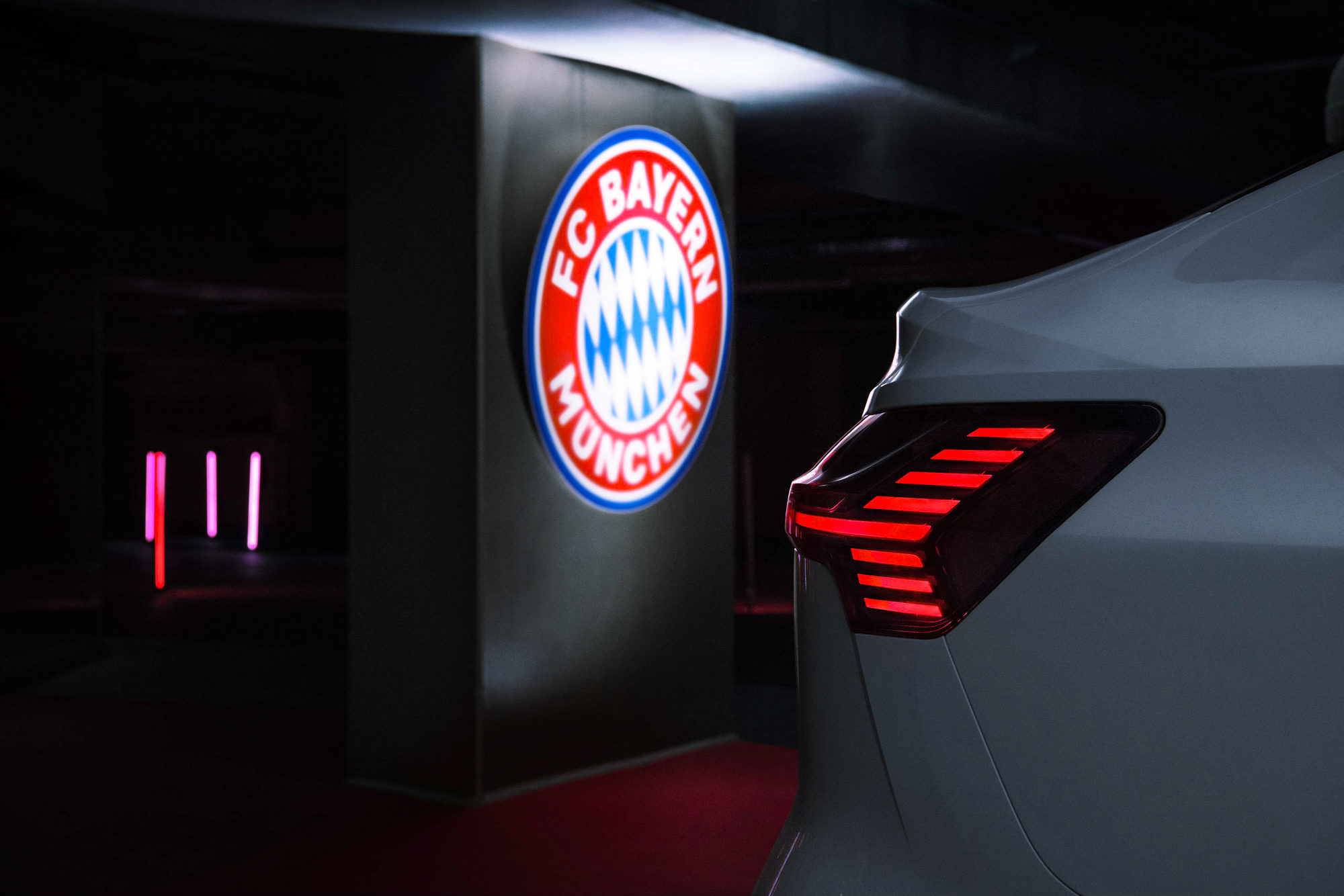 Detail of an Audi e-tron with illuminated FC Bayern logo