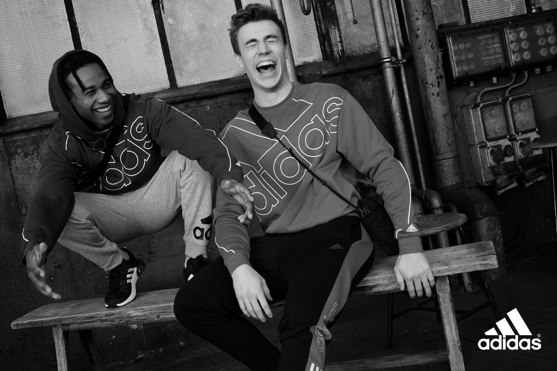Young man wearing Adidas Essentials sportswear in a black and white lifestyle portrait