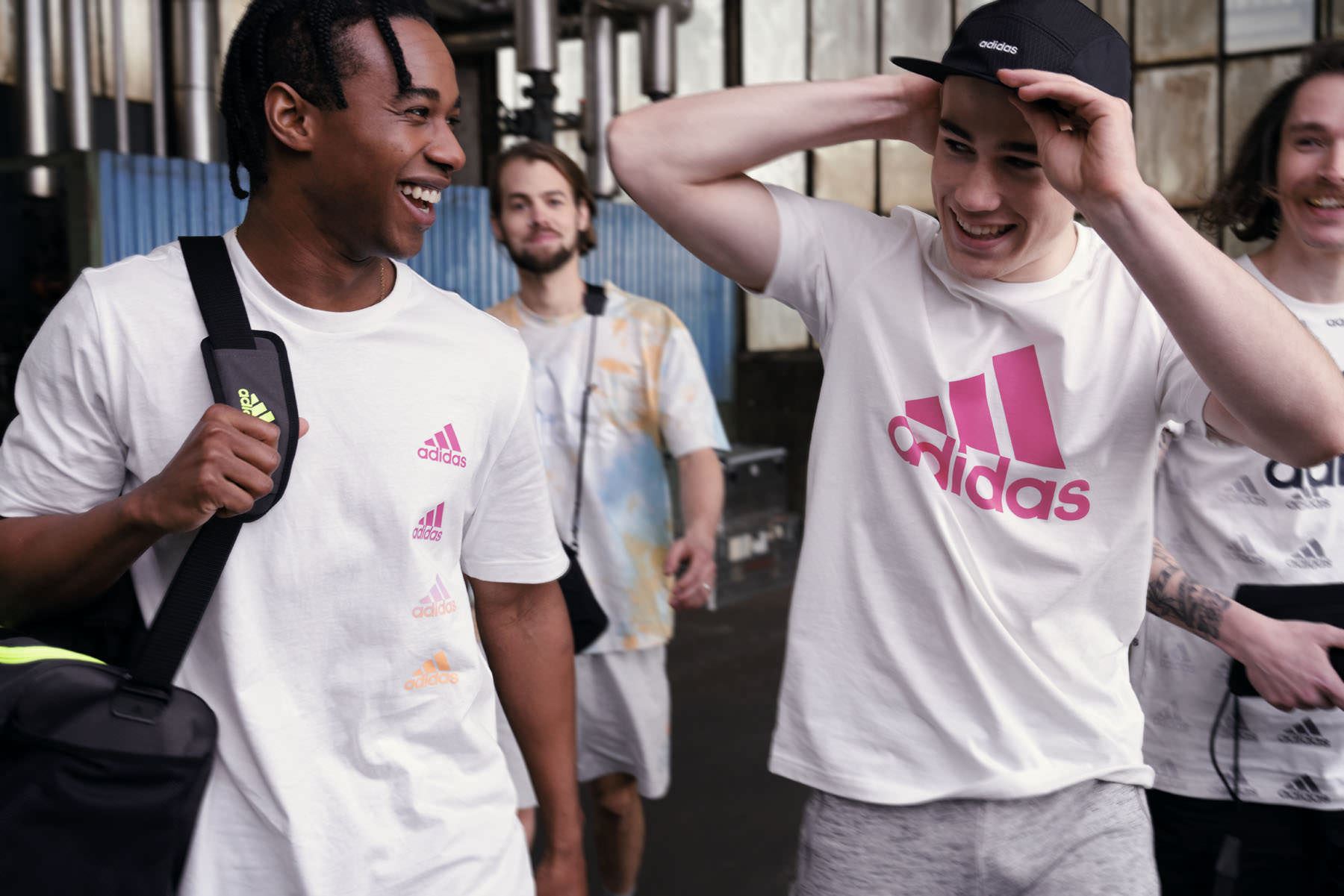 Young men wearing Adidas Essentials sportswear in an urban setting