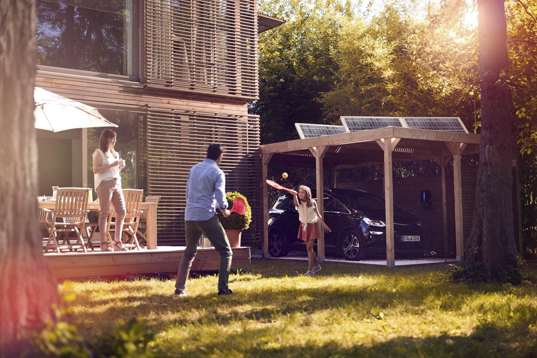 Electric car charging outside a modern home in a lifestyle setting