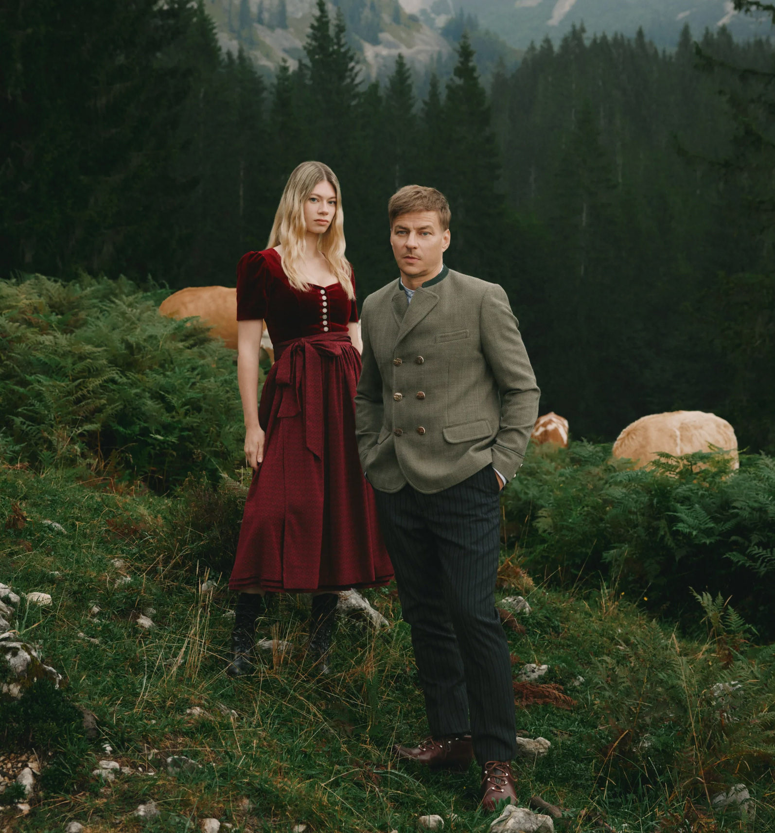 Male and female models wearing traditional alpine clothing in a mountain landscape for Valée Alpura Fragrance campaign