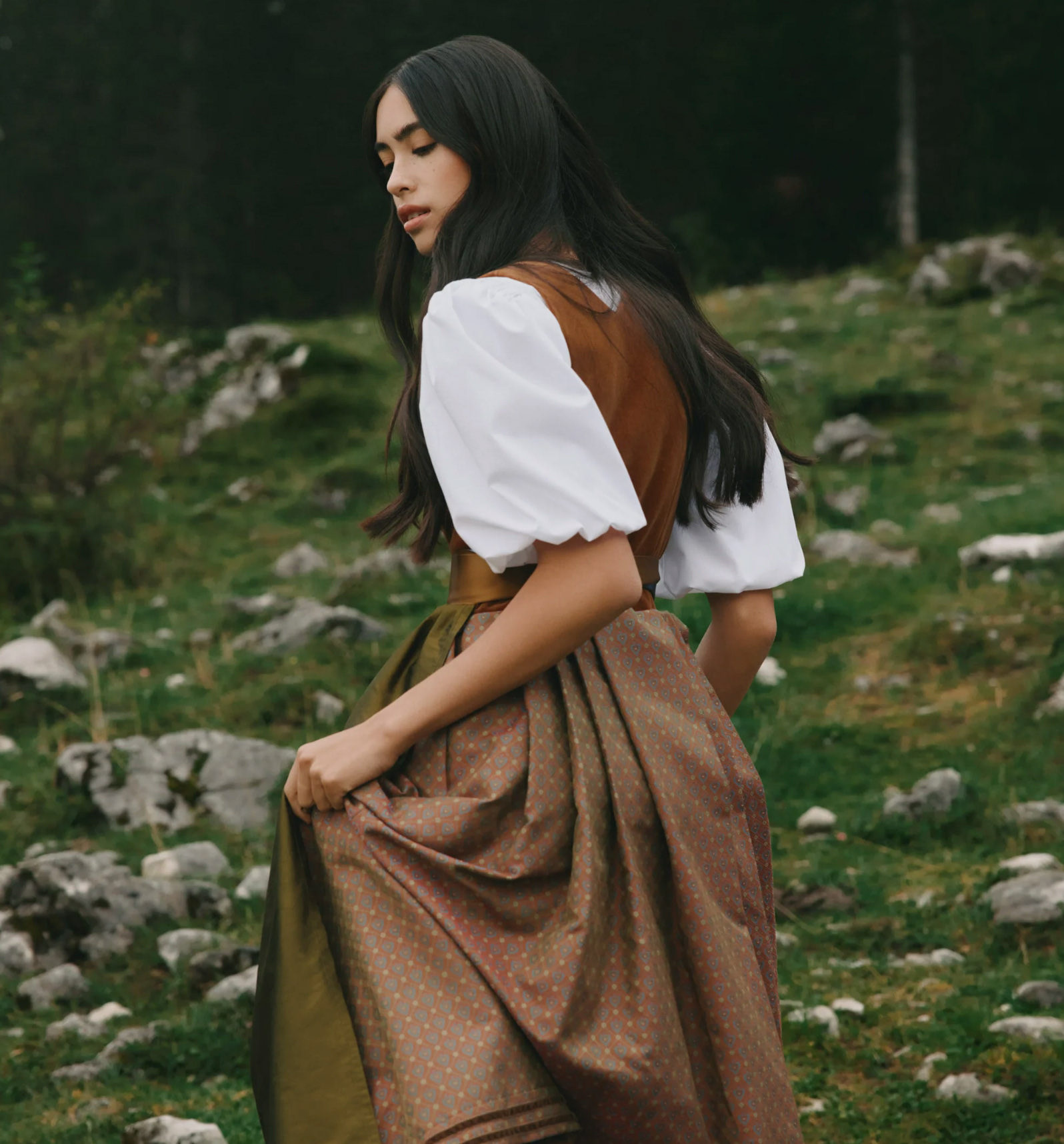 female model wearing traditional alpine clothing in a mountain landscape for Valée Alpura Fragrance campaign